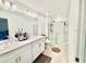 Modern bathroom with double sink vanity, quartz countertops, sleek fixtures, and a glass-enclosed stand up shower at 4520 Calvary Way, St Cloud, FL 34769