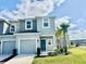 New construction two-story townhouse featuring a one car garage, tropical landscaping, and a welcoming front entrance at 4520 Calvary Way, St Cloud, FL 34769