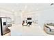 Modern kitchen with white cabinetry, stainless steel appliances, a quartz countertop island, and an open view of the living area at 4520 Calvary Way, St Cloud, FL 34769