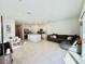 Bright, spacious living area featuring an open concept kitchen with quartz countertops, stainless appliances, and tile flooring at 4520 Calvary Way, St Cloud, FL 34769