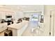 Bright, modern living area featuring an open concept kitchen with quartz countertops, stainless appliances, and access to the patio at 4520 Calvary Way, St Cloud, FL 34769