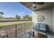 Relaxing balcony with modern furnishings, ceiling fan, and charming decor overlooking the street at 4731 Clock Tower Dr # 104, Kissimmee, FL 34746