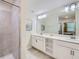 Modern bathroom with double vanity, a large mirror, and glass-enclosed shower at 4731 Clock Tower Dr # 104, Kissimmee, FL 34746