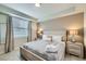 Serene bedroom featuring a queen-sized bed, neutral decor, and ample natural light at 4731 Clock Tower Dr # 104, Kissimmee, FL 34746