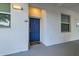 Welcoming entryway featuring a blue front door with sidelight windows and a cozy mat at 4731 Clock Tower Dr # 104, Kissimmee, FL 34746