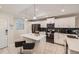 Updated kitchen with white cabinets, stainless steel appliances, a center island, and tile flooring at 4731 Clock Tower Dr # 104, Kissimmee, FL 34746