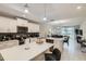 Bright kitchen with white cabinets, stainless steel appliances, a breakfast bar, and an open view to the living area at 4731 Clock Tower Dr # 104, Kissimmee, FL 34746