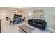 Open-concept living area with modern furnishings, artwork, and a dining area at 4731 Clock Tower Dr # 104, Kissimmee, FL 34746