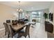 Cozy living and dining space with neutral tones, modern decor, and sliding glass doors to outdoor area at 4731 Clock Tower Dr # 104, Kissimmee, FL 34746