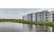 Scenic view of a lake, lush green shoreline, and a connecting boardwalk at 4731 Clock Tower Dr # 104, Kissimmee, FL 34746