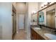 Bathroom with a dual sink granite vanity and tiled shower with glass doors at 4819 Shoreline Cir, Sanford, FL 32771