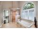 A luxurious bathroom features a soaking tub under a large window and a glass-enclosed shower at 4819 Shoreline Cir, Sanford, FL 32771
