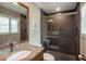 Modern bathroom with glass enclosed shower, granite vanity, and wood-look tile at 4819 Shoreline Cir, Sanford, FL 32771