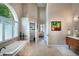 Bright bathroom featuring a soaking tub, modern vanity, and a view to a bedroom at 4819 Shoreline Cir, Sanford, FL 32771
