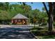 Lake Forest gate house features well maintained landscaping in a gated community with mature trees at 4819 Shoreline Cir, Sanford, FL 32771