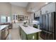 Bright kitchen featuring an island, stainless steel appliances, tile backsplash, and white cabinetry at 4819 Shoreline Cir, Sanford, FL 32771