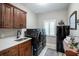 Functional laundry room with sleek washer/dryer, sink, and storage cabinets, enhanced by natural light from a window at 4819 Shoreline Cir, Sanford, FL 32771