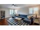 Cozy living room with a large sectional couch, and a black and white checkered rug at 4819 Shoreline Cir, Sanford, FL 32771