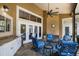 Covered patio with outdoor kitchen, comfortable seating, and view of the pool at 4819 Shoreline Cir, Sanford, FL 32771