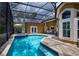 Beautiful screened pool with spa, patio area, and lush landscaping at 4819 Shoreline Cir, Sanford, FL 32771