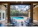 Screened pool area with outdoor seating and lush landscaping offering a relaxing retreat at 4819 Shoreline Cir, Sanford, FL 32771