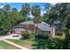 Spacious two-story home featuring a large lawn and mature trees, with a side-entry garage at 4819 Shoreline Cir, Sanford, FL 32771