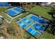 Aerial view of well-maintained tennis courts within a lush community setting at 4819 Shoreline Cir, Sanford, FL 32771