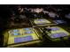 Nighttime aerial view of lit tennis courts and lake in the community at 4819 Shoreline Cir, Sanford, FL 32771