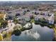 An aerial view of the community featuring a pool, water feature, and landscaping near the apartment buildings at 4833 Cypress Woods Dr # 4101, Orlando, FL 32811