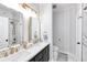 Bright bathroom featuring double vanity with gold hardware and a marble tiled shower at 4833 Cypress Woods Dr # 4101, Orlando, FL 32811