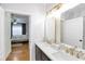 Bathroom with double vanity and gold fixtures and a bedroom with a ceiling fan at 4833 Cypress Woods Dr # 4101, Orlando, FL 32811