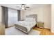 Cozy bedroom offers a mirrored bed frame, soft carpet, and sheer curtains for filtered sunlight at 4833 Cypress Woods Dr # 4101, Orlando, FL 32811