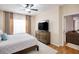Bedroom featuring a bed frame, and dresser with a TV at 4833 Cypress Woods Dr # 4101, Orlando, FL 32811