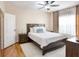 Cozy bedroom with a wooden bed frame, decorative pillows, and hardwood floors at 4833 Cypress Woods Dr # 4101, Orlando, FL 32811