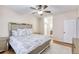 Beautiful bedroom with ceiling fan and large bed with an ornate silver headboard at 4833 Cypress Woods Dr # 4101, Orlando, FL 32811