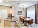 Bright dining area features a modern chandelier and a wooden dining table with comfortable, stylish chairs at 4833 Cypress Woods Dr # 4101, Orlando, FL 32811