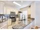 This bright kitchen features stainless steel appliances, white cabinets, and granite countertops at 4833 Cypress Woods Dr # 4101, Orlando, FL 32811