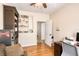 Bright office boasts hardwood floors, built-in shelving and displays, and a door leading to other rooms at 4833 Cypress Woods Dr # 4101, Orlando, FL 32811