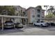 Exterior parking spaces under metal carports for resident parking with multiple vehicles present at 4833 Cypress Woods Dr # 4101, Orlando, FL 32811