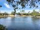 A community pond with a fountain in the middle, surrounded by trees and landscaping at 4833 Cypress Woods Dr # 4101, Orlando, FL 32811