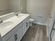 Bathroom features a double sink vanity, and wood-look tile flooring, offering style and functionality at 5099 Prairie Preserve Run, St Cloud, FL 34772