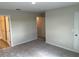 This is a bedroom with gray carpet and a bathroom; it offers style and functionality at 5099 Prairie Preserve Run, St Cloud, FL 34772