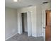 Neutral bedroom showcases a closet and an interior door, complemented by carpet and light-colored walls at 5099 Prairie Preserve Run, St Cloud, FL 34772