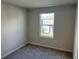 This bedroom has carpet flooring, neutral walls and a window with a view to the outside at 5099 Prairie Preserve Run, St Cloud, FL 34772