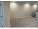 Upstairs bonus room with neutral carpet, paint, and staircase; a versatile space for relaxation or play at 5099 Prairie Preserve Run, St Cloud, FL 34772