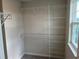 Walk-in closet with wire shelving and a window, offering organized storage solutions and natural light at 5099 Prairie Preserve Run, St Cloud, FL 34772