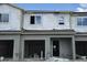 Unfinished townhouse exterior featuring garage and windows at 5099 Prairie Preserve Run, St Cloud, FL 34772