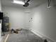 Unfinished garage with bare concrete floors and a hot water heater at 5099 Prairie Preserve Run, St Cloud, FL 34772