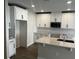 Bright kitchen showcases white cabinets, an island with sink, and a stainless steel microwave at 5099 Prairie Preserve Run, St Cloud, FL 34772
