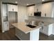 New kitchen featuring an island, stainless steel microwave, white cabinetry, and subway tile backsplash at 5099 Prairie Preserve Run, St Cloud, FL 34772